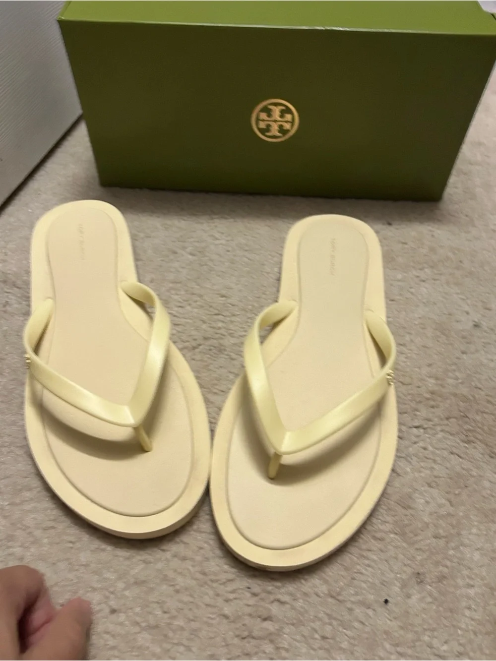 TORY BURCH KIRA padded flip flops in light yellow.